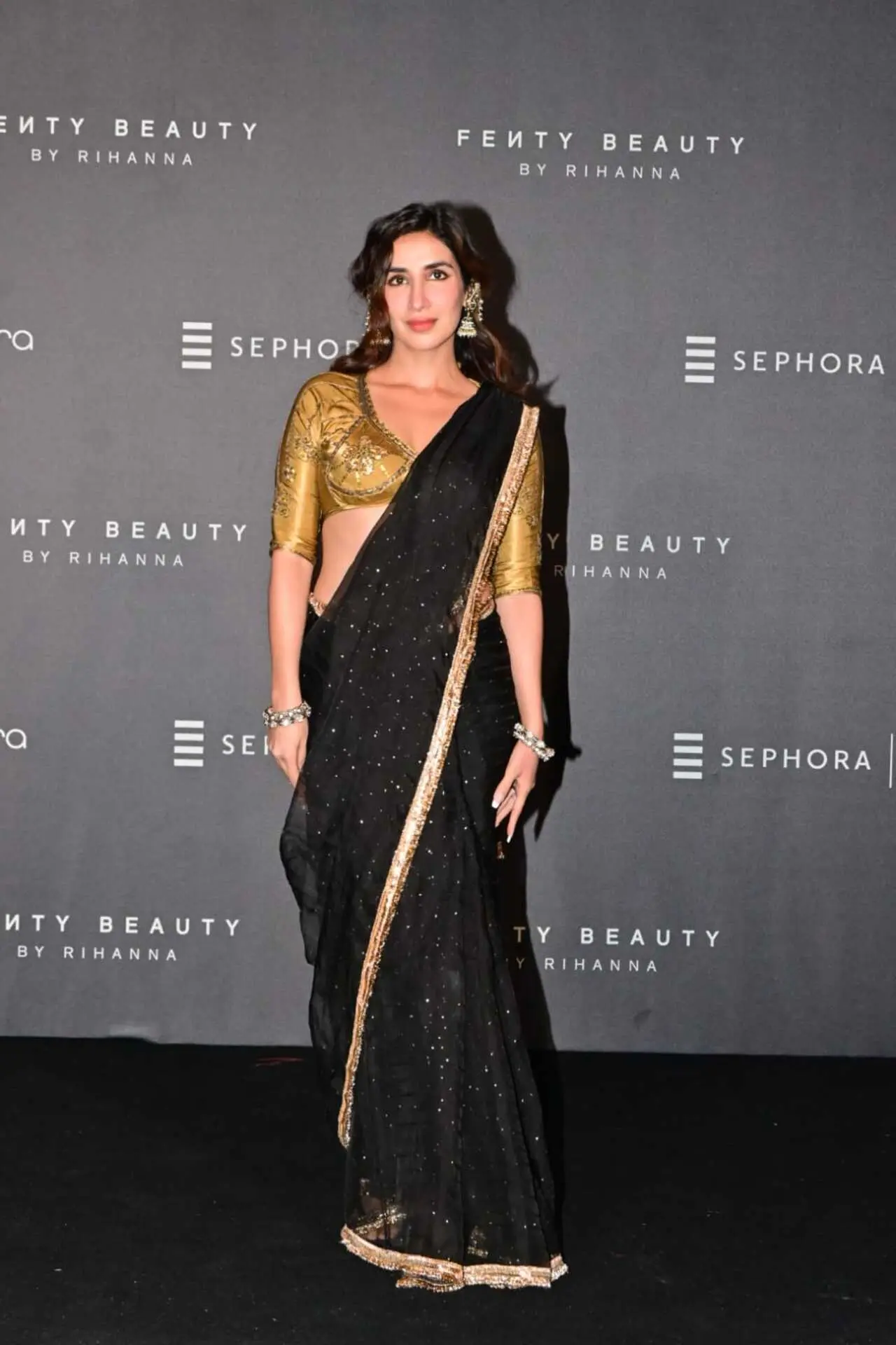 Actress Parul Gulati made a striking appearance in a black saree with golden borders paired with a golden blouse at the event.